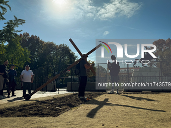 A man carries a large wooden cross near the White House in Washington DC, USA on 05 November, 2024. (