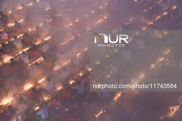 Hindu devotees sit together on the floor of Loknath Temple to observe the Rakher Upobash festival to honor Baba Lokenath, an 18th Century Hi...