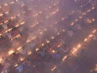 Hindu devotees sit together on the floor of Loknath Temple to observe the Rakher Upobash festival to honor Baba Lokenath, an 18th Century Hi...