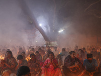 Hindu devotees sit together on the floor of Loknath Temple to observe the Rakher Upobash festival to honor Baba Lokenath, an 18th Century Hi...