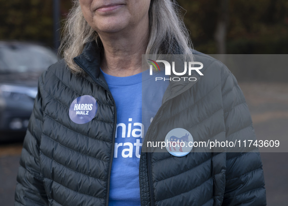 A supporter of Kamala Harris stands outside a Vote Center in Fairfax County, Virginia, on November 5, 2024. 