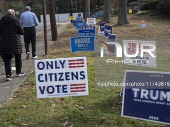 Presidential candidates Donald Trump and Kamala Harris' signs are seen outside a Vote Center in Fairfax County, Virginia, on November 5, 202...