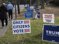 Presidential candidates Donald Trump and Kamala Harris' signs are seen outside a Vote Center in Fairfax County, Virginia, on November 5, 202...