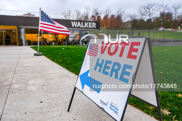 A sign points to a polling location and an American flag stands in front of the Walker Art Center in Minneapolis, Minnesota, on November 5,...