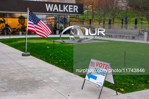 A sign points to a polling location and an American flag stands in front of the Walker Art Center in Minneapolis, Minnesota, on November 5,...