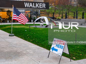 A sign points to a polling location and an American flag stands in front of the Walker Art Center in Minneapolis, Minnesota, on November 5,...