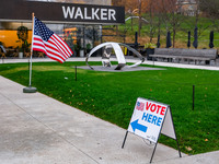 A sign points to a polling location and an American flag stands in front of the Walker Art Center in Minneapolis, Minnesota, on November 5,...