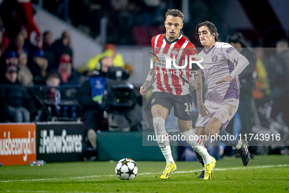 PSV Eindhoven forward Noa Lang and Girona FC forward Bryan Gil play during the match between PSV and Girona at the Philips Stadium for the U...