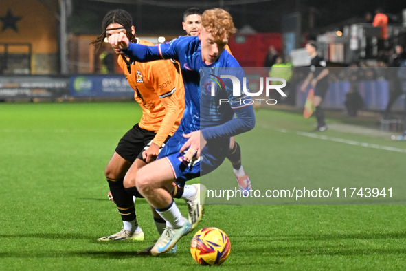 Brodie Hughes (44 Chelsea) is challenged by Amaru Kaunda (37 Cambridge United) during the EFL Trophy match between Cambridge United and Chel...