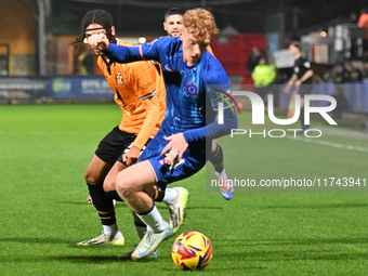 Brodie Hughes (44 Chelsea) is challenged by Amaru Kaunda (37 Cambridge United) during the EFL Trophy match between Cambridge United and Chel...