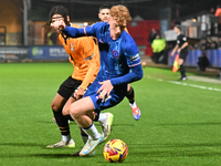 Brodie Hughes (44 Chelsea) is challenged by Amaru Kaunda (37 Cambridge United) during the EFL Trophy match between Cambridge United and Chel...