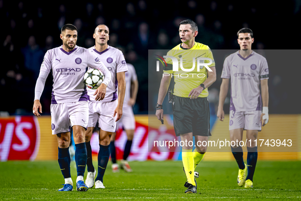 Girona FC defender David Lopez and referee Michael Oliver participate in the match between PSV and Girona at the Philips Stadium for the UEF...