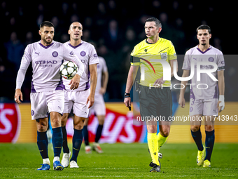 Girona FC defender David Lopez and referee Michael Oliver participate in the match between PSV and Girona at the Philips Stadium for the UEF...