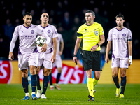 Girona FC defender David Lopez and referee Michael Oliver participate in the match between PSV and Girona at the Philips Stadium for the UEF...