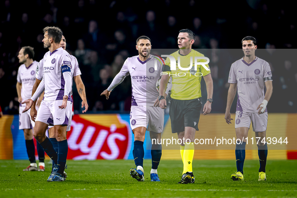 Girona FC defender David Lopez and referee Michael Oliver participate in the match between PSV and Girona at the Philips Stadium for the UEF...