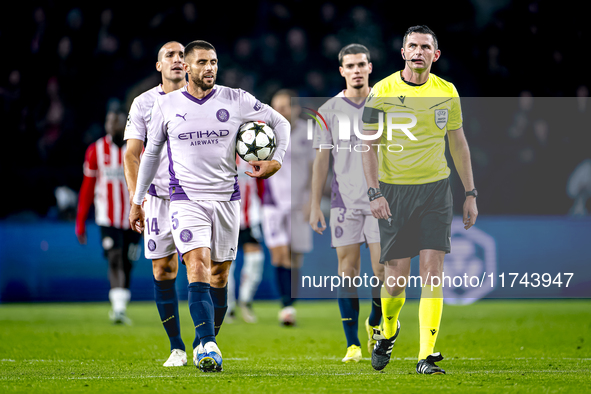 Girona FC defender David Lopez and referee Michael Oliver participate in the match between PSV and Girona at the Philips Stadium for the UEF...