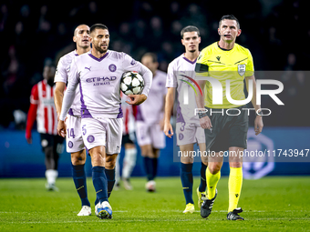 Girona FC defender David Lopez and referee Michael Oliver participate in the match between PSV and Girona at the Philips Stadium for the UEF...