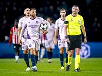 Girona FC defender David Lopez and referee Michael Oliver participate in the match between PSV and Girona at the Philips Stadium for the UEF...