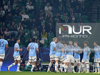 Phil Foden of Manchester City celebrates with his teammates after scoring his team's first goal during the UEFA Champions League match betwe...