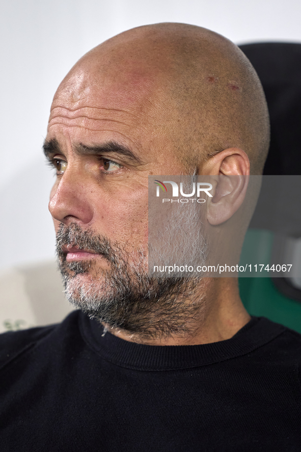 Pep Guardiola, Head Coach of Manchester City, looks on prior to the UEFA Champions League match between Sporting CP and Manchester City at J...