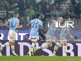 Phil Foden of Manchester City celebrates with his teammates after scoring his team's first goal during the UEFA Champions League match betwe...