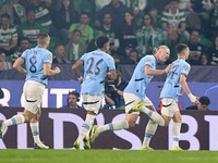 Phil Foden of Manchester City celebrates with his teammates after scoring his team's first goal during the UEFA Champions League match betwe...