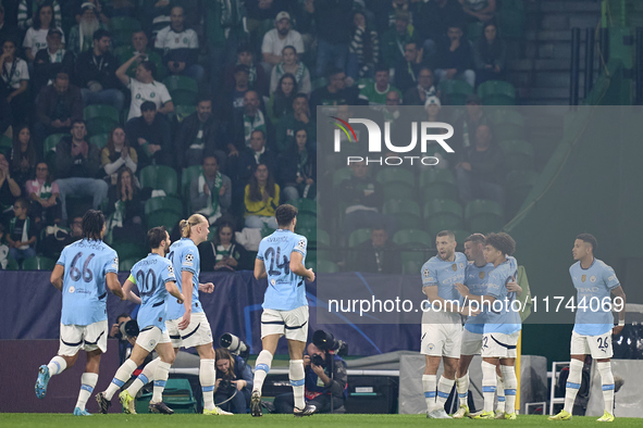 Phil Foden of Manchester City celebrates with his teammates after scoring his team's first goal during the UEFA Champions League match betwe...