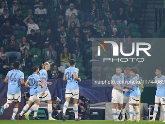 Phil Foden of Manchester City celebrates with his teammates after scoring his team's first goal during the UEFA Champions League match betwe...