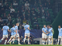 Phil Foden of Manchester City celebrates with his teammates after scoring his team's first goal during the UEFA Champions League match betwe...