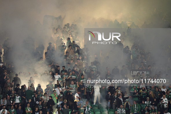 Fans of Sporting CP light flares in the stand during the UEFA Champions League match between Sporting CP and Manchester City at Jose Alvalad...