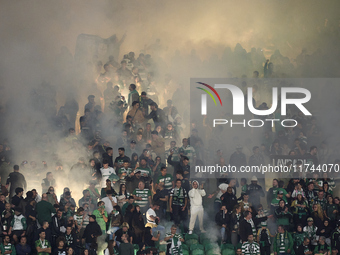 Fans of Sporting CP light flares in the stand during the UEFA Champions League match between Sporting CP and Manchester City at Jose Alvalad...