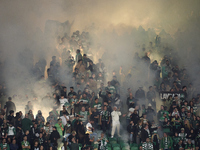 Fans of Sporting CP light flares in the stand during the UEFA Champions League match between Sporting CP and Manchester City at Jose Alvalad...