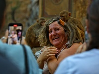 A tourist poses with a macaque at the Shrine Galta Ji Temple in Jaipur, Rajasthan, India, on November 5, 2024. (