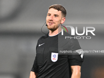 Referee David Harrison officiates during the EFL Trophy match between Cambridge United and Chelsea Under 21s at the Cledara Abbey Stadium in...