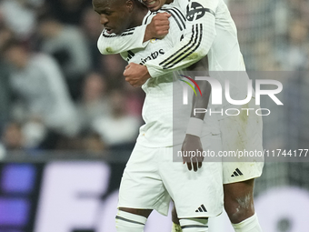 Vinicius Junior left winger of Real Madrid and Brazil celebrates after scoring his sides first goal with Jude Bellingham central midfield of...