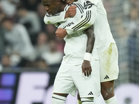 Vinicius Junior left winger of Real Madrid and Brazil celebrates after scoring his sides first goal with Jude Bellingham central midfield of...