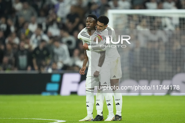 Vinicius Junior left winger of Real Madrid and Brazil celebrates after scoring his sides first goal with Jude Bellingham central midfield of...