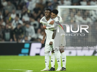 Vinicius Junior left winger of Real Madrid and Brazil celebrates after scoring his sides first goal with Jude Bellingham central midfield of...