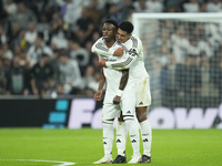 Vinicius Junior left winger of Real Madrid and Brazil celebrates after scoring his sides first goal with Jude Bellingham central midfield of...