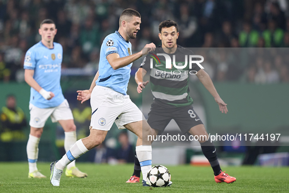 Mateo Kovacic of Manchester City is challenged by Pedro Goncalves of Sporting CP during the UEFA Champions League match between Sporting CP...