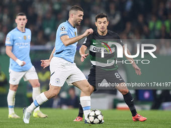 Mateo Kovacic of Manchester City is challenged by Pedro Goncalves of Sporting CP during the UEFA Champions League match between Sporting CP...