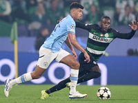 Matheus Nunes of Manchester City is challenged by Geovany Quenda of Sporting CP during the UEFA Champions League match between Sporting CP a...