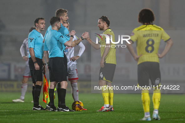 Referee Scott Oldham shakes hands with #4, Elliot Watt of Burton Albion during the Sky Bet League 1 match between Burton Albion and Crawley...