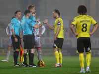 Referee Scott Oldham shakes hands with #4, Elliot Watt of Burton Albion during the Sky Bet League 1 match between Burton Albion and Crawley...