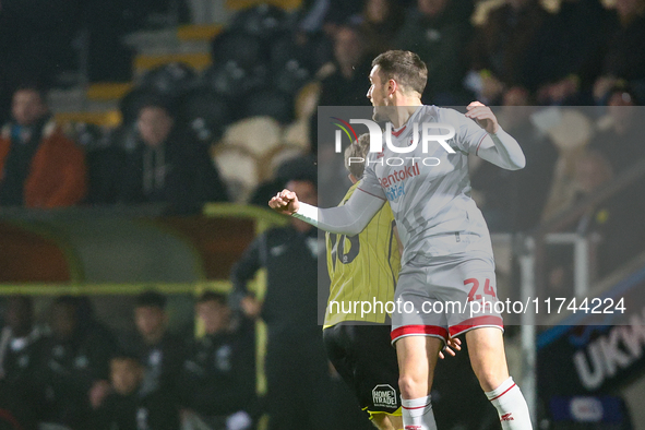 #24, Toby Mullarkey of Crawley Town outjumps #16, Jack Cooper-Love of Burton Albion during the Sky Bet League 1 match between Burton Albion...