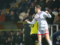 #24, Toby Mullarkey of Crawley Town outjumps #16, Jack Cooper-Love of Burton Albion during the Sky Bet League 1 match between Burton Albion...