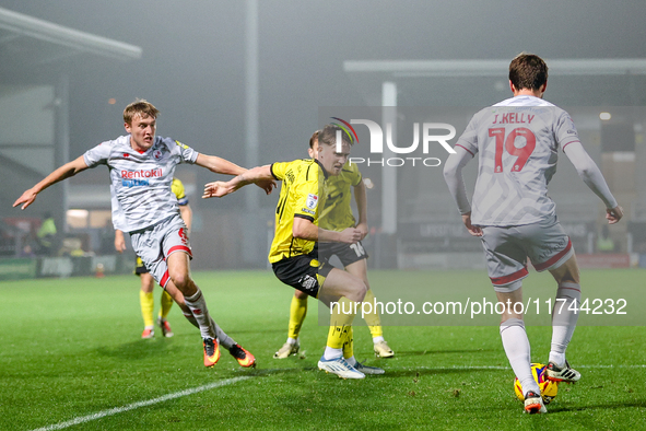 #21, Alex Bannon of Burton Albion loses out to #19, Jeremy Kelly of Crawley Town during the Sky Bet League 1 match between Burton Albion and...