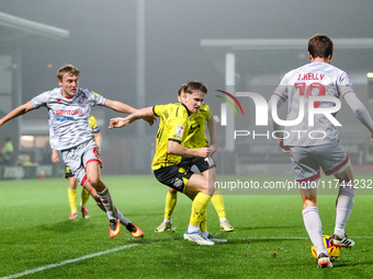 #21, Alex Bannon of Burton Albion loses out to #19, Jeremy Kelly of Crawley Town during the Sky Bet League 1 match between Burton Albion and...