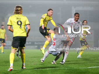 Number 34, Ben Whitfield of Burton Albion (center), attempts a shot on goal during the Sky Bet League 1 match between Burton Albion and Craw...