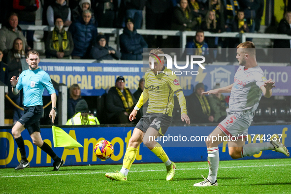 Charlie Barker of Crawley Town races to intercept Ben Whitfield of Burton Albion during the Sky Bet League 1 match between Burton Albion and...